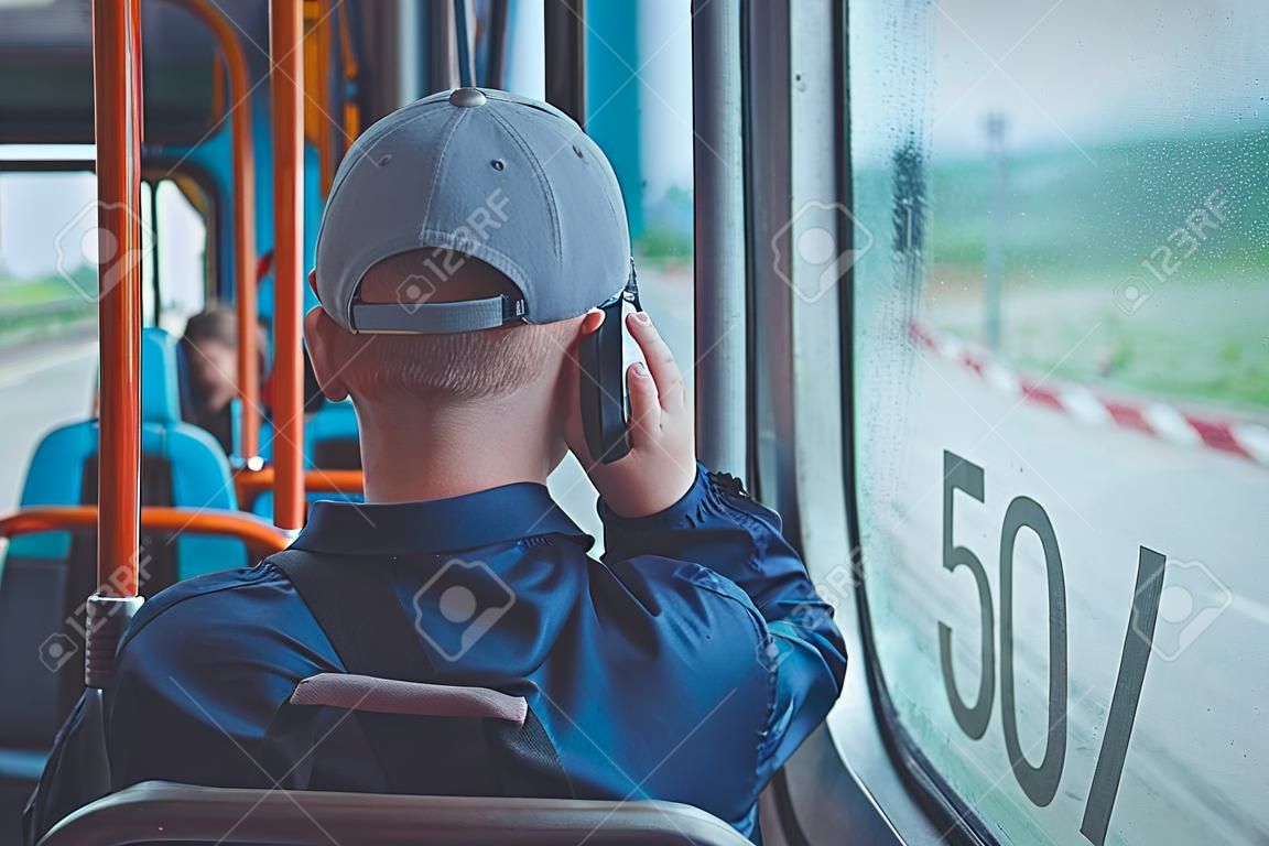 A child in public transport talks on the phone