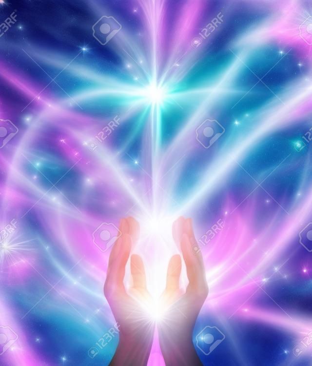 Beaming Reiki Healing Energy  Male parallel hands facing upwards with a beam of bright white energy flowing up on a pink and blue ethereal energy formation background