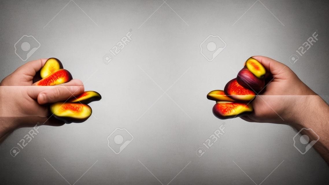 Trade and military conflict between Ukraine and Russia. Conceptual photo of two fists with figs isolated on a white background.