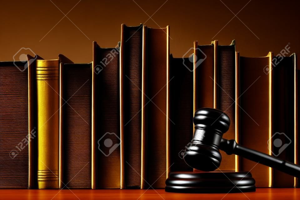 Court hammer and books on black background. Court chambers, office of judge. Law and trial.