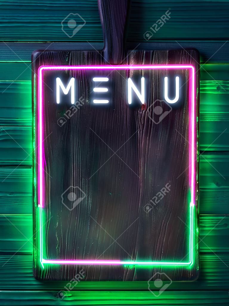 vintage wooden brown cutting board with neon green and pink lights, menu signboard, template for restaurant, pub, copy space