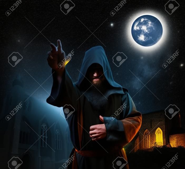 Medieval monk against church at night