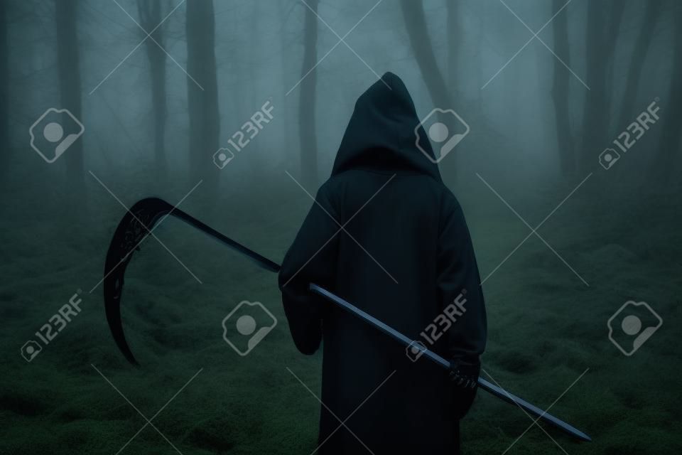 Death in a black hoodie with a scythe in forest
