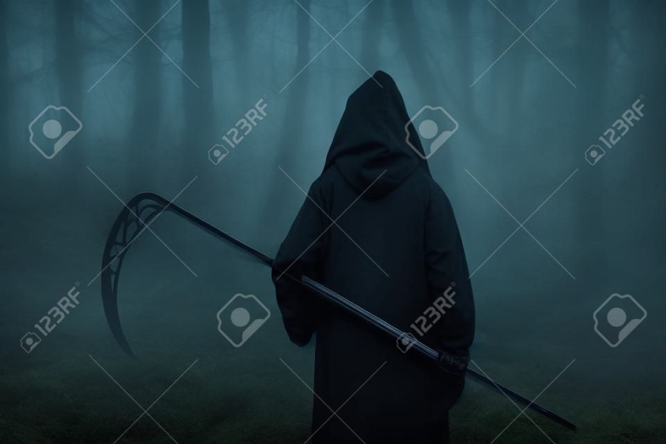 Death in a black hoodie with a scythe in forest