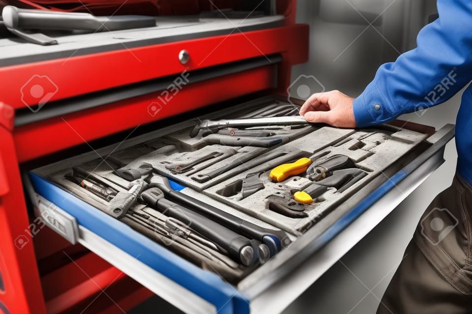Repairman hand reaching for the tool box