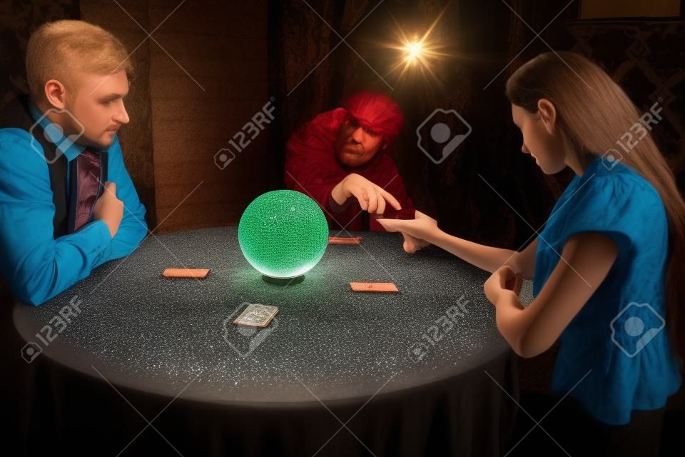 Foreteller guessing by hand over a crystal ball