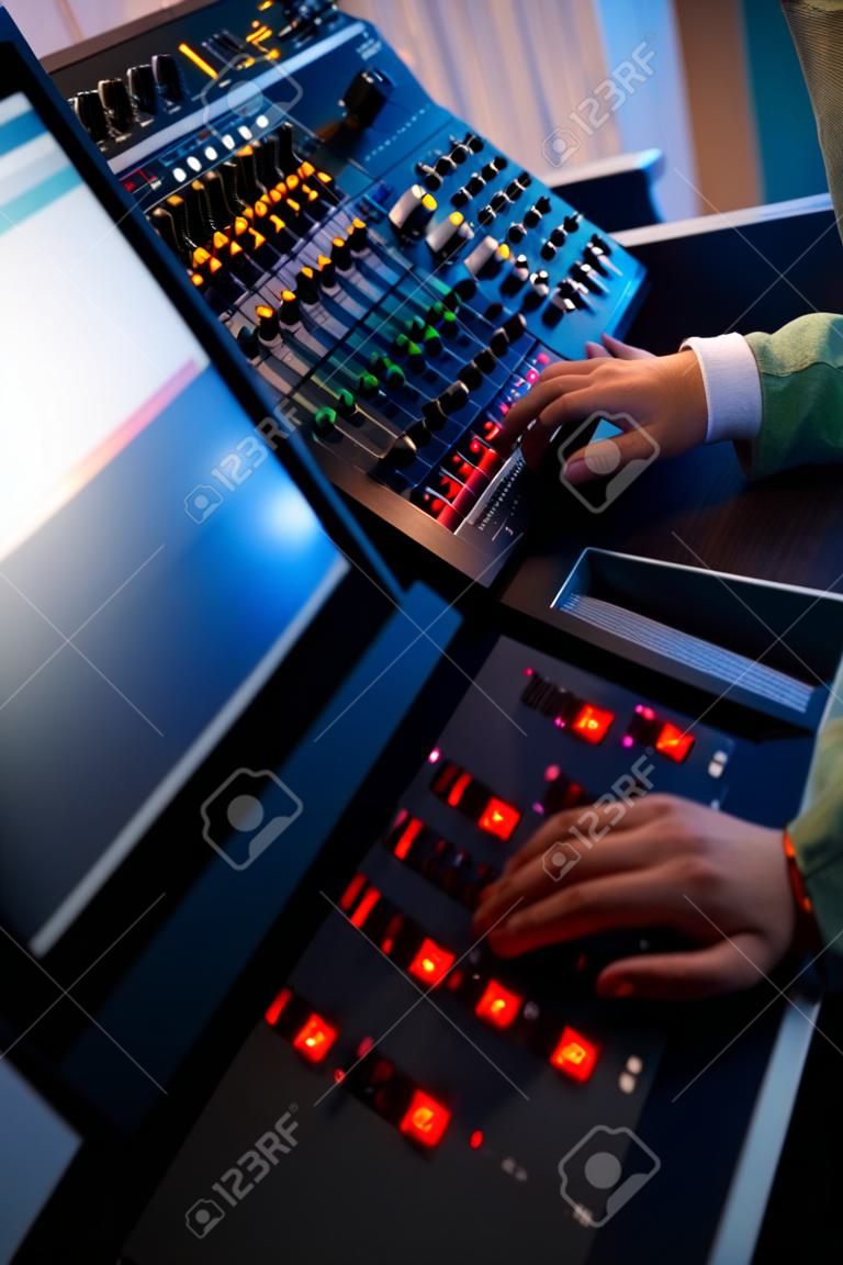 Closeup audio engineer hand mixing sound