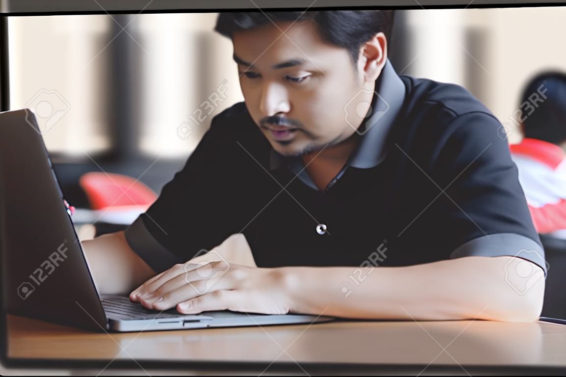 Businessman using laptop at desk in busy office.
Young man working on notebook sitting in coffee shop.
Close up hands typing on computer keyboard on table, online business marketing concept.