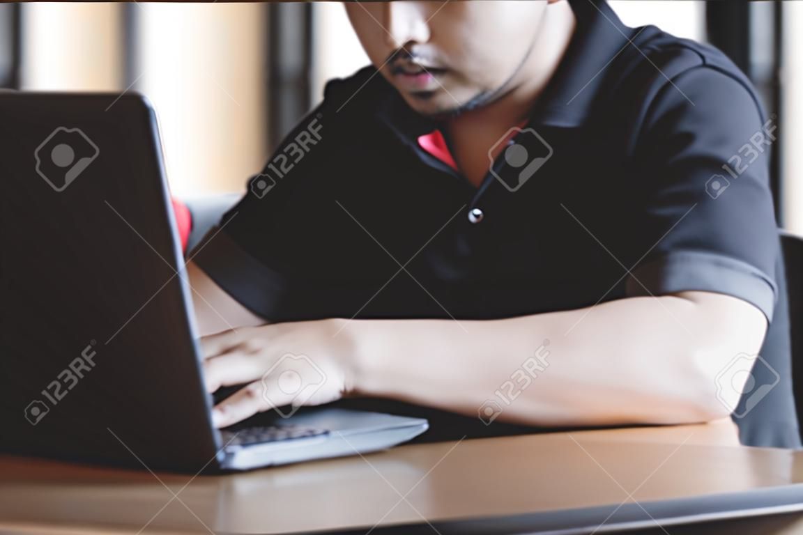 Businessman using laptop at desk in busy office.
Young man working on notebook sitting in coffee shop.
Close up hands typing on computer keyboard on table, online business marketing concept.