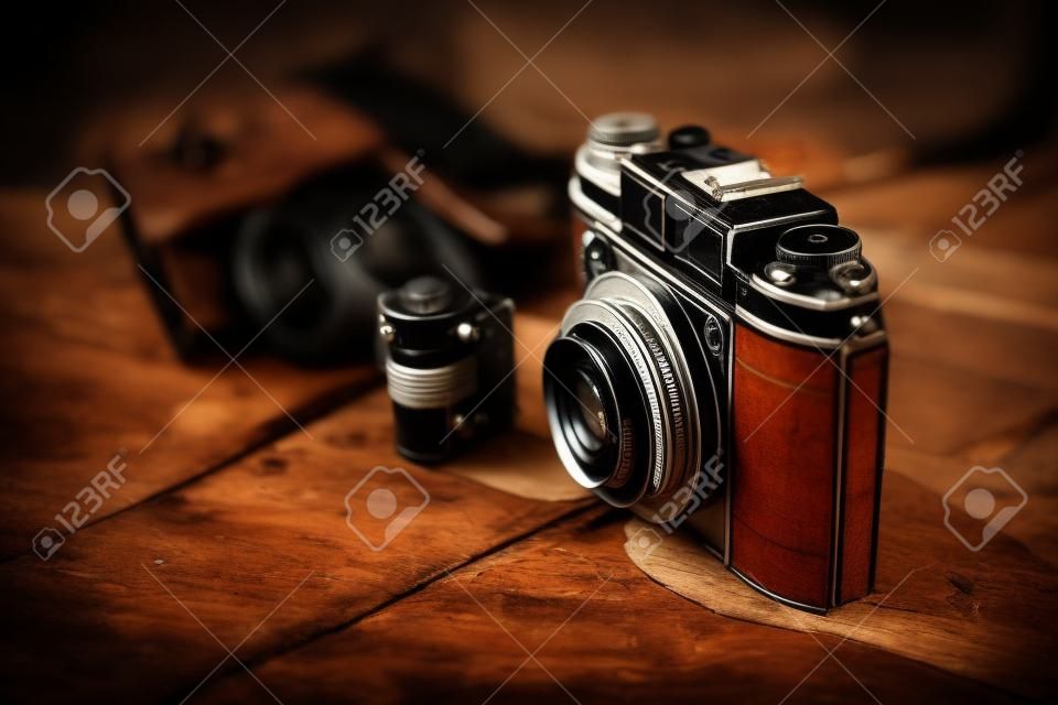 Old film camera on wooden desktop.