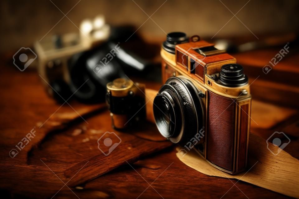 Old film camera on wooden desktop.