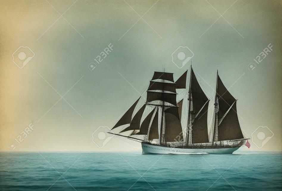 Three mast schooner under sails on the baltic sea  Cross processed 