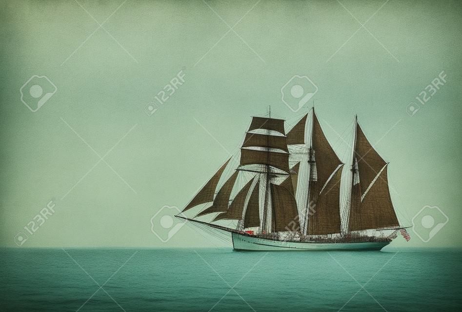 Three mast schooner under sails on the baltic sea  Cross processed 