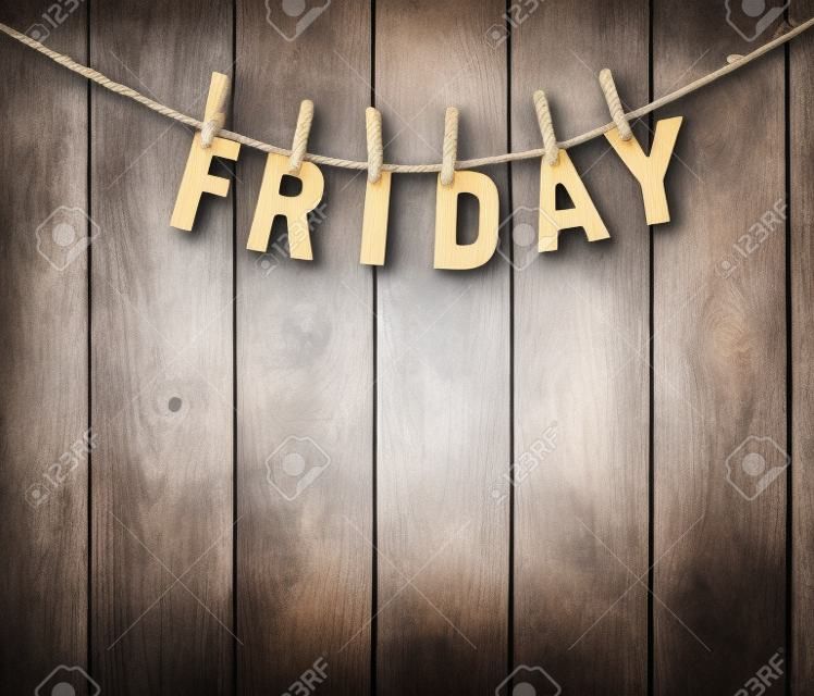 Friday word by wooden letters hang with rope on wood background (Weekdays word series)