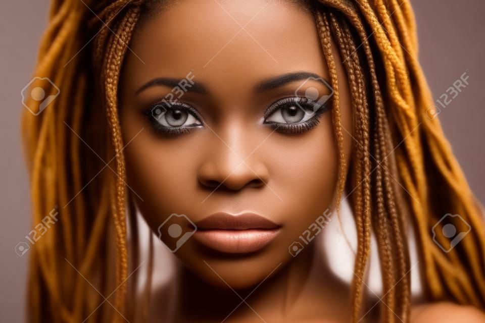 Portrait of a beautiful young African woman with braids, close-up.