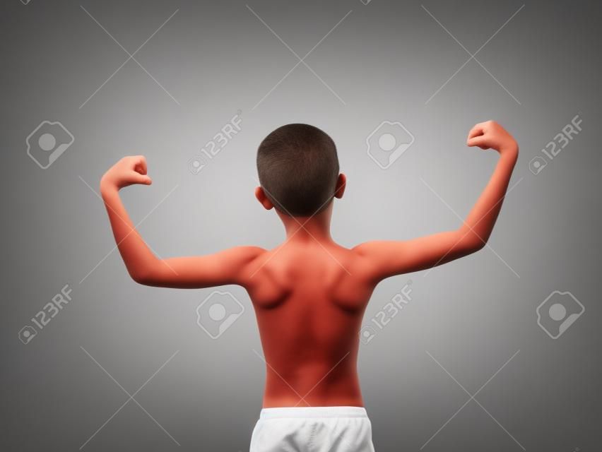 Back of Thin boy showing his muscles isolated on white background