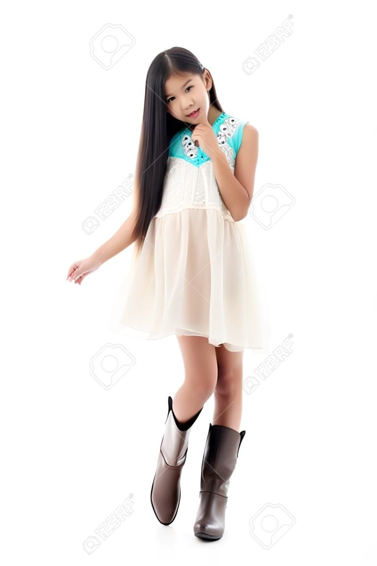 Cute Asian teenager wearing dress and boots on white.