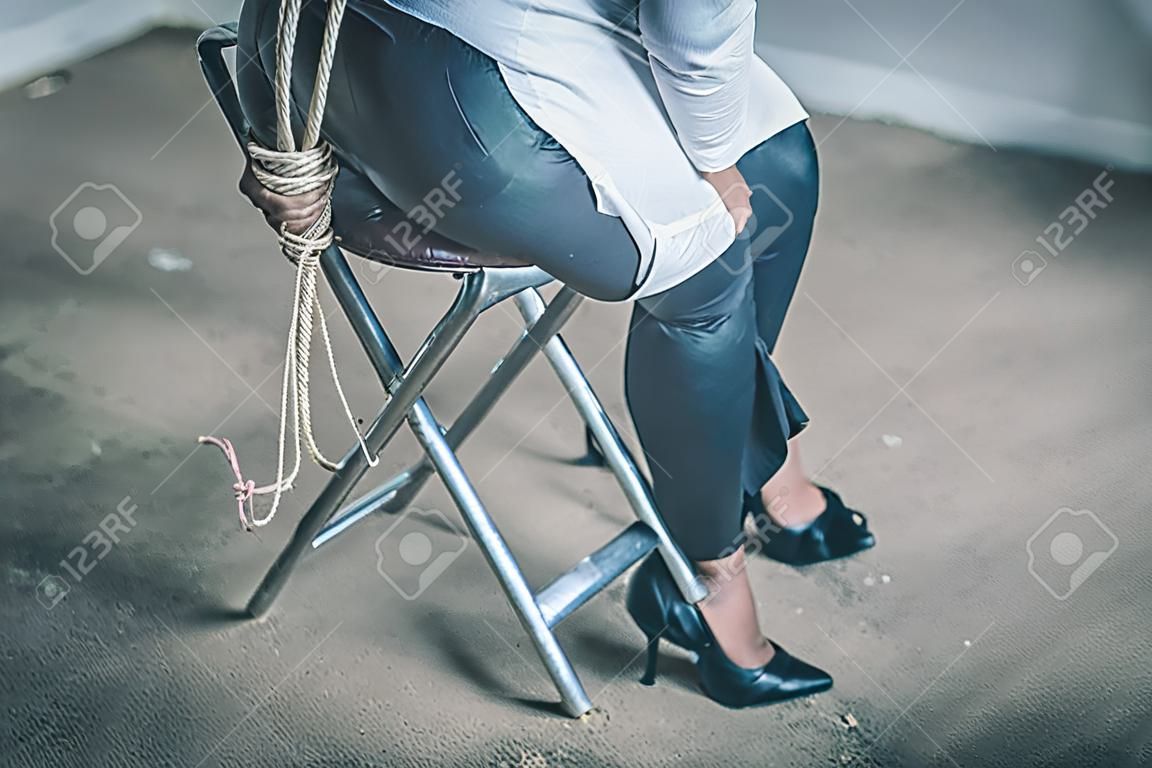 woman hands bound. Women were handcuffed and Sitting on a chair.woman tied hand to a chair.Crime Concept.Criminality Concept.
Bonded business.
