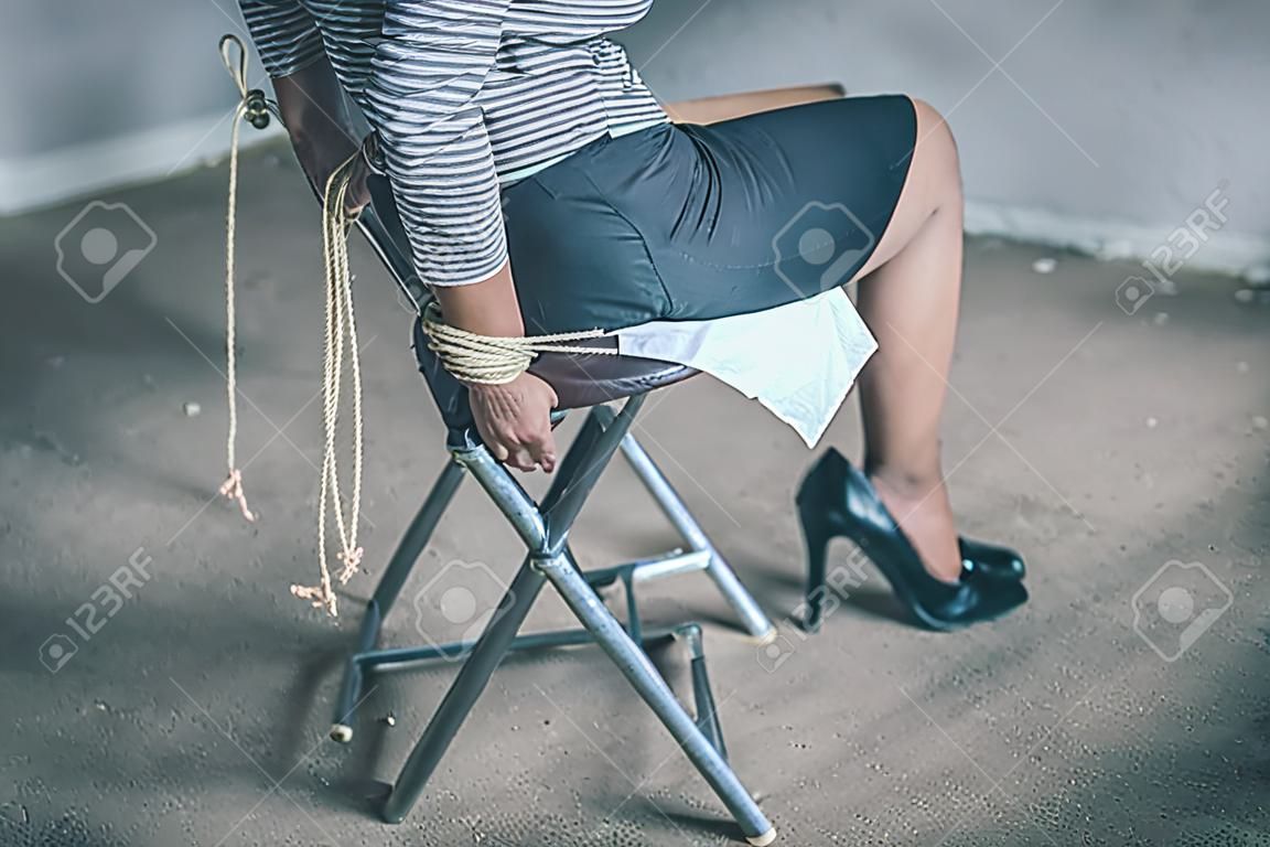 woman hands bound. Women were handcuffed and Sitting on a chair.woman tied hand to a chair.Crime Concept.Criminality Concept.
Bonded business.