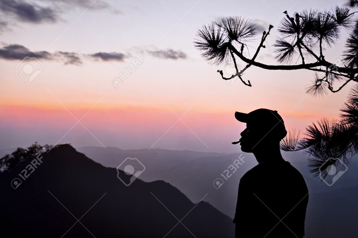 Silhouette of man on the mountain with sunrise. Element of design.