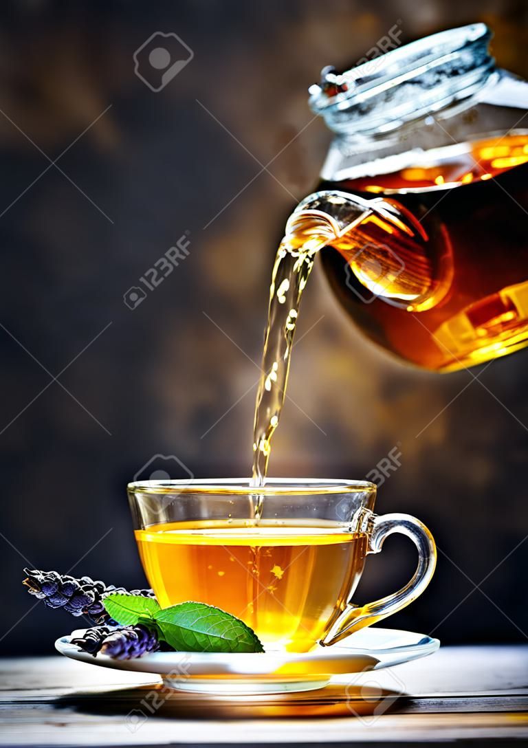 Process brewing tea,tea ceremony. Cup of freshly brewed black tea,warm soft light.