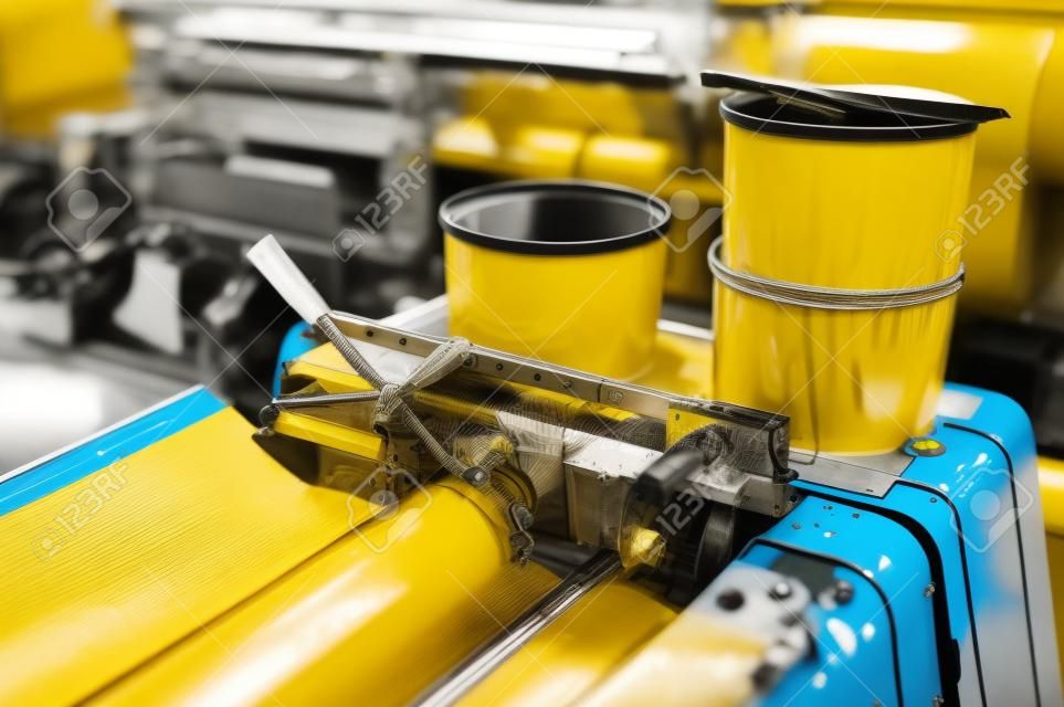 detail of offset printing machine with ink tanks yellow