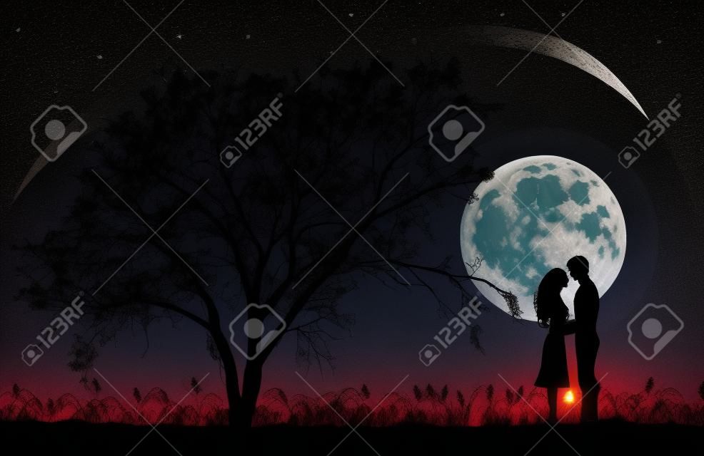 Silhouettes of man and woman hugging at night time with a Tree silhouette. Giant beautiful full moon in the sky.