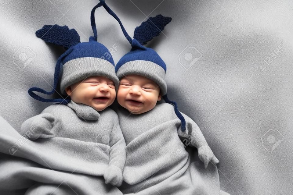two twins brothers babies weared in acorn hats