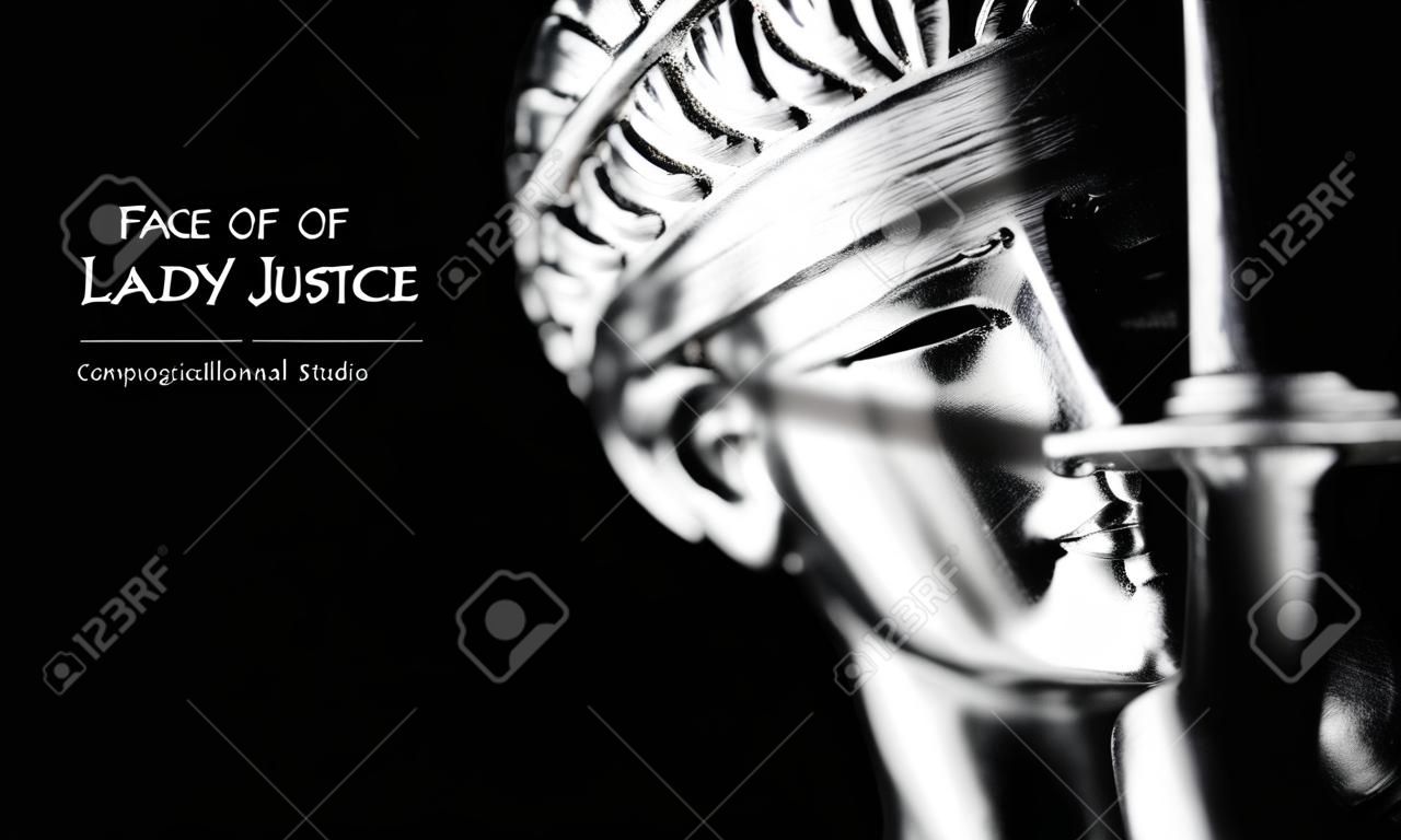 Face of Lady Justice in black background and space for text