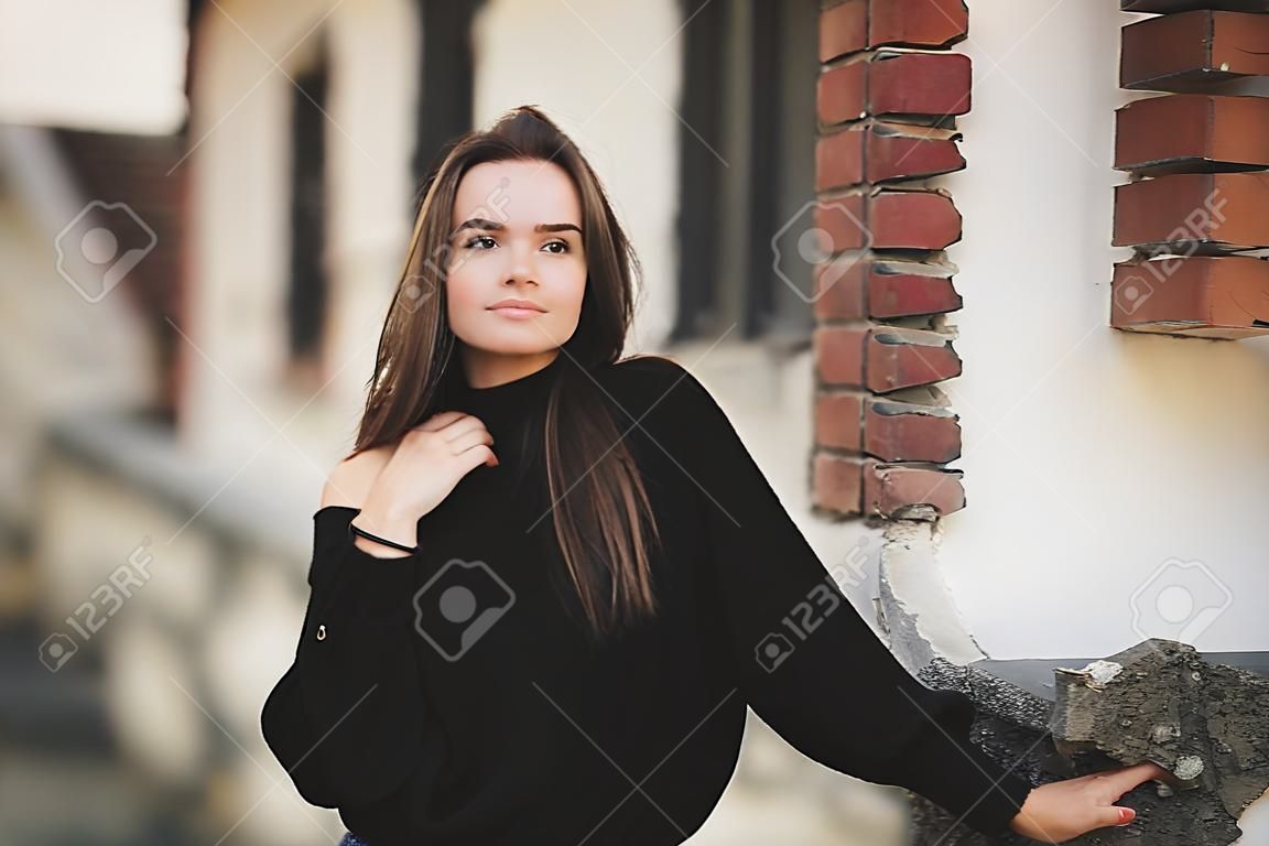 Portrait of a young beautiful woman in a urban background