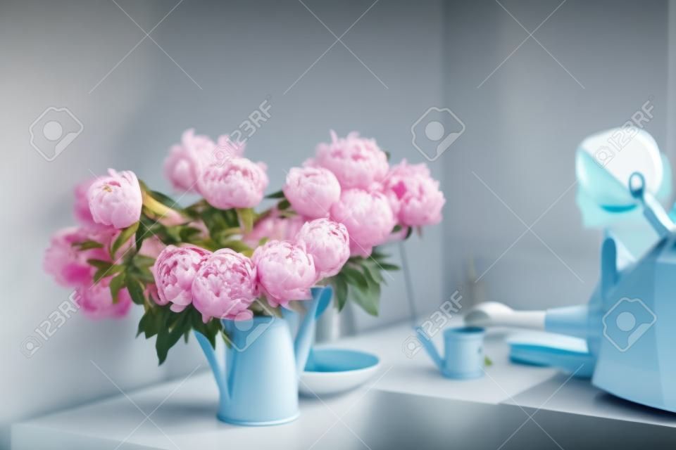 peonies in a garden watering can, a desktop in the home