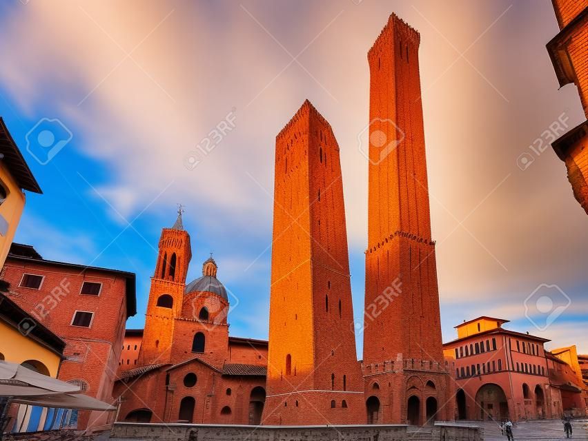 Two Towers, Asinelli and Garisenda, both of them leaning, symbol of Bologna, statue of San Petronius and Church of Saints Bartholomew and Gaetano in the morning, Bologna, Emilia-Romagna, Italy