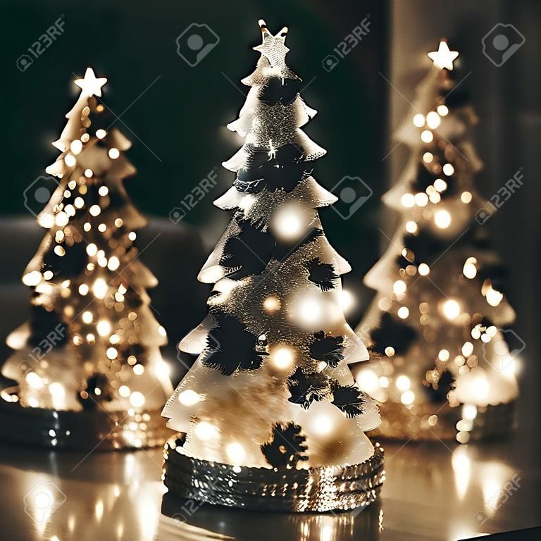 Merry Christmas. Stylish Christmas shiny Christmas trees with golden lights. Modern holiday decor.