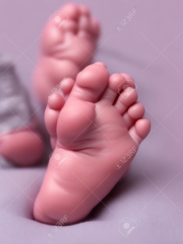 The baby's small feet are very close, people