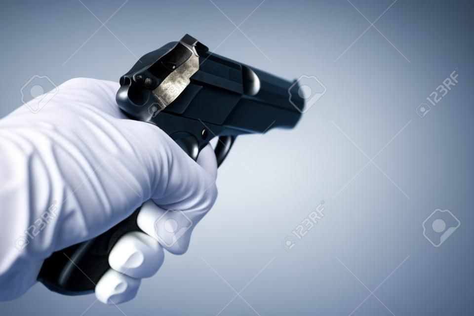 Gun in hand isolated on white background.