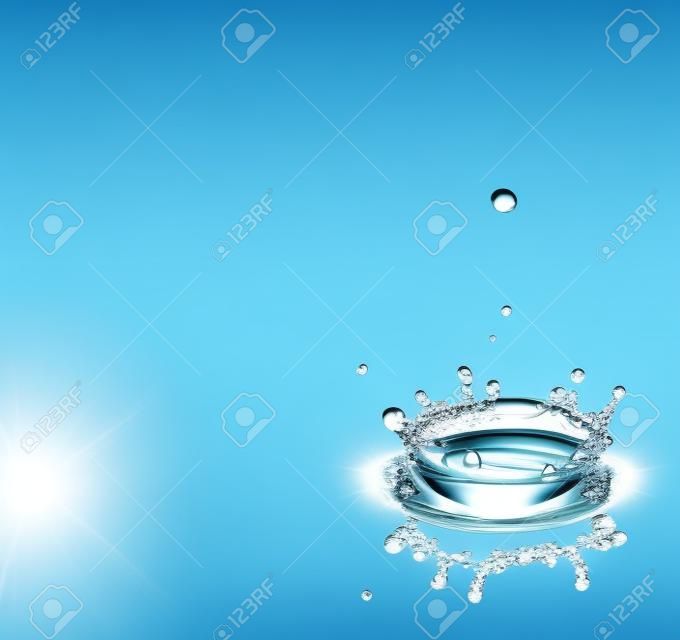 Water drops splashing a clear blue background with reflexion and room for your text.