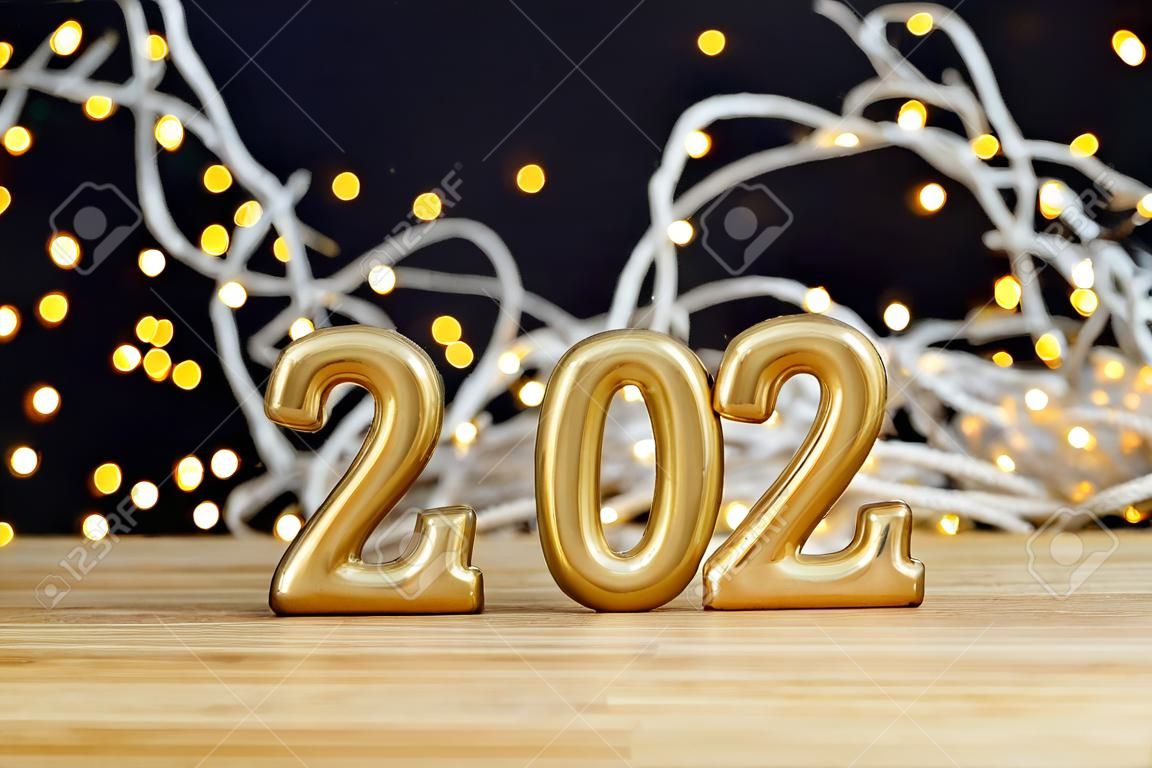 Background for greetings with empty space. Happy new year card. Figures 2024 on a wooden table on black background. Front view