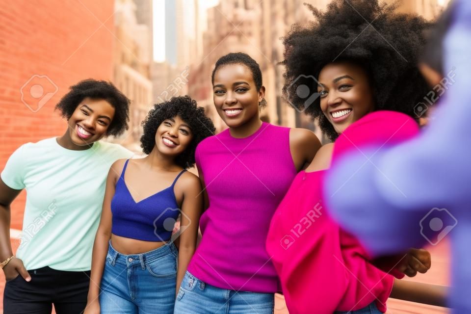 Group of afroamerican friends bonding in Manhattan, New York - Young adults having fun outdoors, concepts about lifestyle and young adult generation