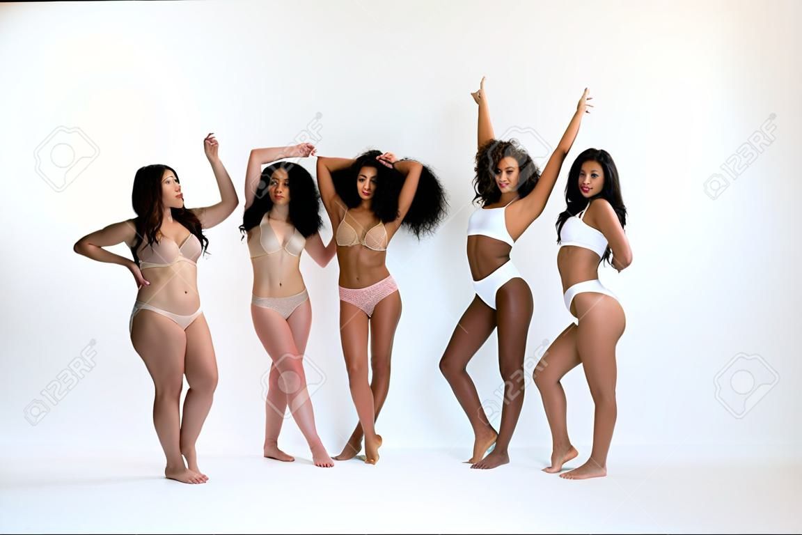 Multi-ethnic group of beautiful women posing in underwear in a beauty studio - Multicultural fashion models showing their beautiful bodies as they are, concepts about beauty, acceptance and diversity