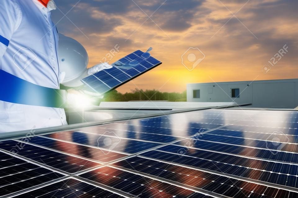 Engineers are examining the performance graph of energy production from solar panels that are alternative energy and which is the concept of sustainable resources.