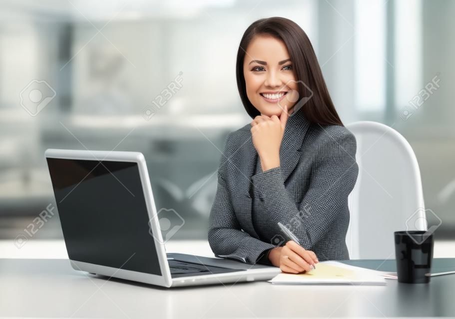 Business woman working on laptop computer at office