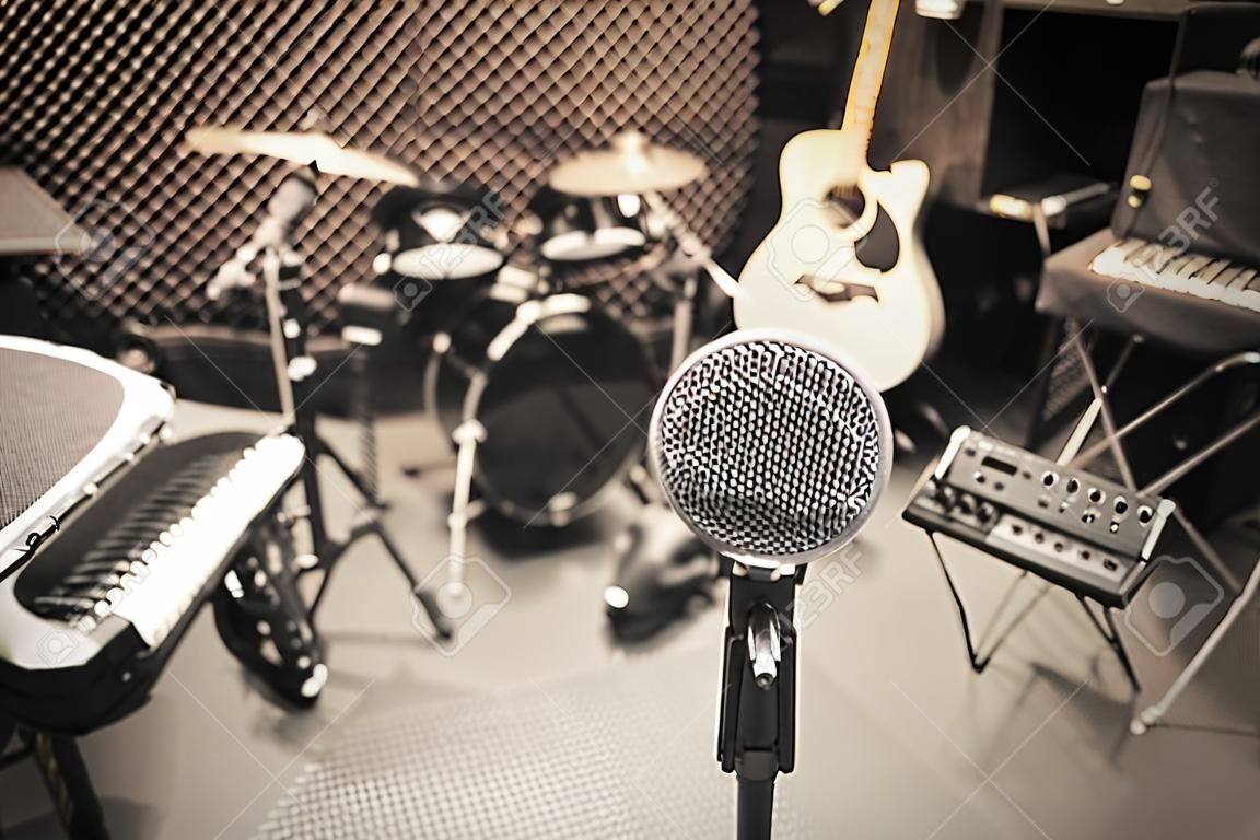 selective focus microphone and blur musical equipment guitar ,lyric, drum piano background.