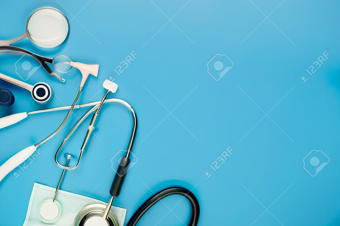 Table top view aerial image of accessories healthcare & medical background concept.Essential instruments or equipment tools on blue paper.Flat lay essential items for doctor using treat patient.