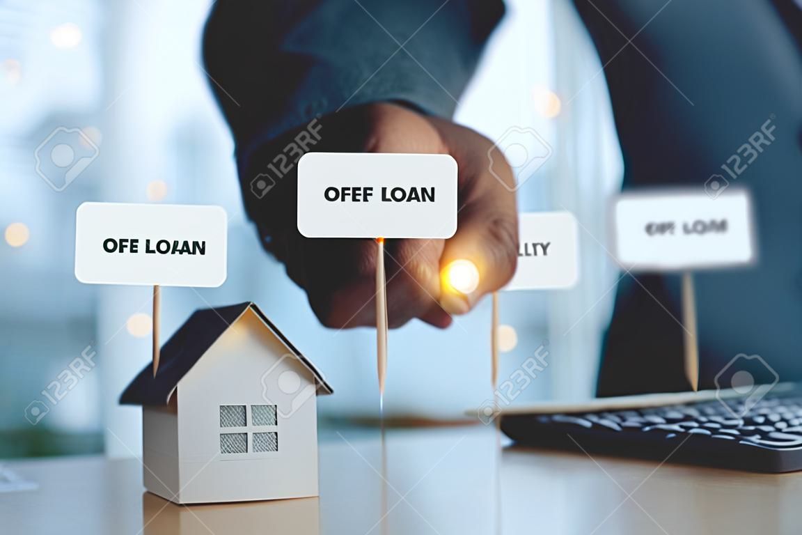 Businessman holding model house paper with message detail. Real estate property investment, mortgage agent offer, bank home loan for housing ownership, Business and Finance insurance concept.