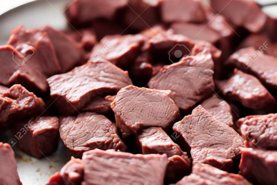 Pieces of beef cooking in frying pan