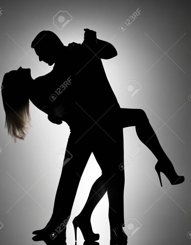 one caucasian couple lovers  man and woman dancing tango in studio silhouette isolated on white background