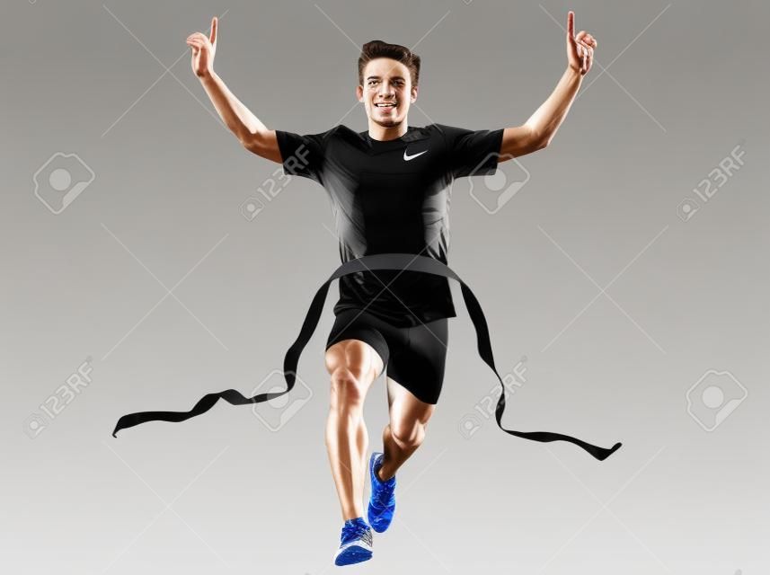 een Kaukasische man jonge sprinter runner loopt winnaar aan de finish lijn in silhouet studio op witte achtergrond