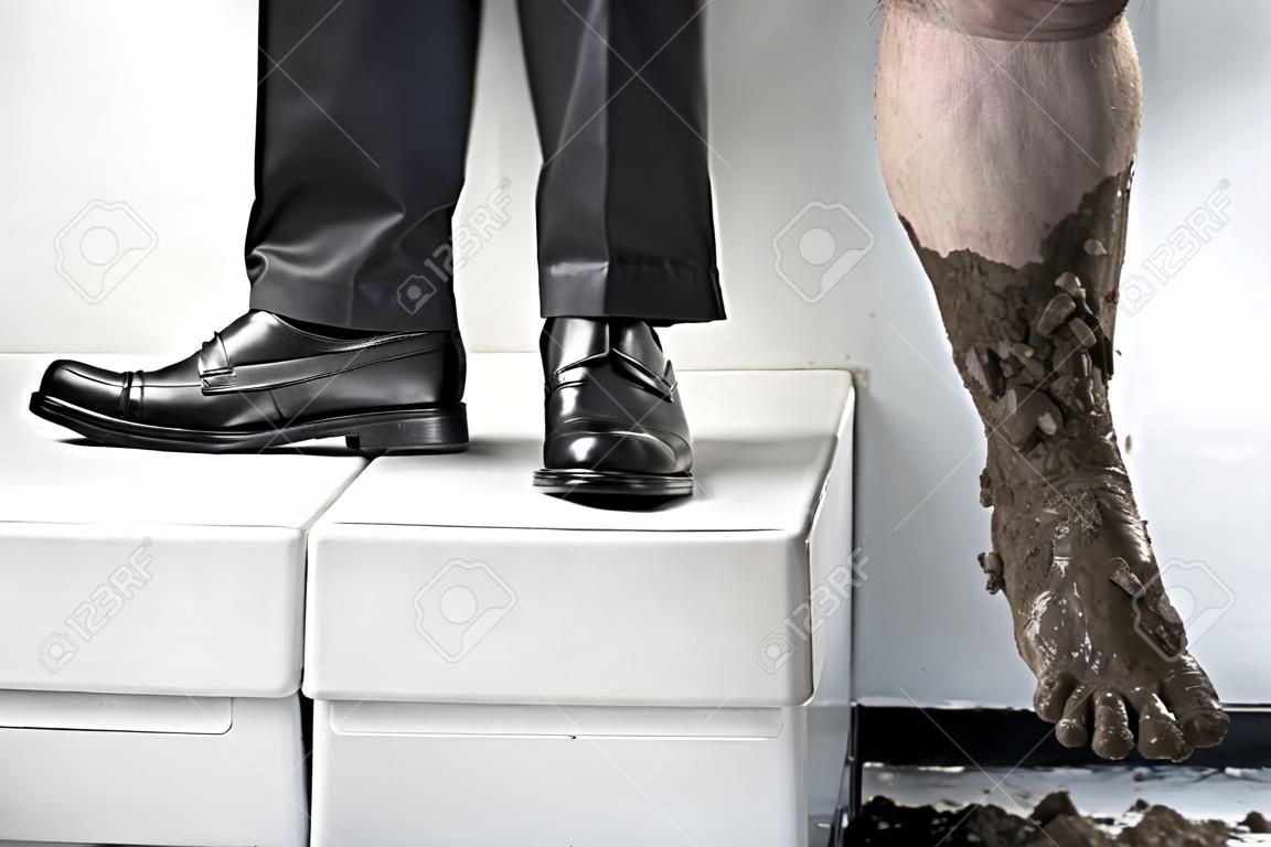 Success concept from poor to be rich, one leg step from below with full of mud and the other leg using business attire. Legs of one person, without compositing
