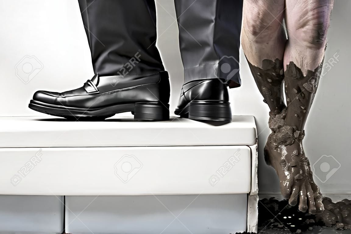 Success concept from poor to be rich, one leg step from below with full of mud and the other leg using business attire. Legs of one person, without compositing