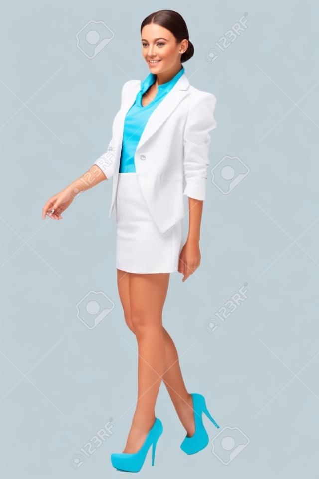 Full length of young business woman walking isolated on white